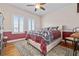 Inviting bedroom with hardwood floors, bright windows, a patterned area rug, and stylish furnishings at 1432 Gopher Loop, Tarpon Springs, FL 34689