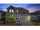Charming two-story home featuring a covered front porch, well-maintained lawn, and an attached two-car garage at 1432 Gopher Loop, Tarpon Springs, FL 34689