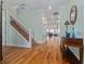 Inviting foyer with hardwood floors and staircase leading to the second level, providing an open and airy feel at 1432 Gopher Loop, Tarpon Springs, FL 34689