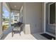 Inviting front porch with comfortable seating, perfect for relaxing and enjoying the neighborhood views at 1432 Gopher Loop, Tarpon Springs, FL 34689