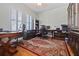 Spacious home office with hardwood floors, bright windows, and built in cabinets at 1432 Gopher Loop, Tarpon Springs, FL 34689