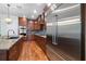 Gourmet kitchen with premium stainless steel appliances and warm wood cabinetry, ideal for culinary enthusiasts at 1432 Gopher Loop, Tarpon Springs, FL 34689