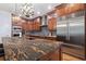 Modern kitchen featuring granite counters, stainless steel appliances, and custom cabinetry, perfect for cooking and entertaining at 1432 Gopher Loop, Tarpon Springs, FL 34689