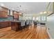 Modern open-concept kitchen with island, breakfast bar, stainless steel appliances, flowing into living space at 1432 Gopher Loop, Tarpon Springs, FL 34689