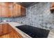 Modern kitchen features granite countertops, tiled backsplash, and stainless steel appliances, perfect for culinary creativity at 1432 Gopher Loop, Tarpon Springs, FL 34689
