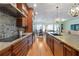 Elegant kitchen flowing into the dining area, complete with cherry cabinets, granite countertops and stainless appliances at 1432 Gopher Loop, Tarpon Springs, FL 34689