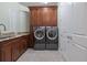 Convenient laundry room with front loading washer and dryer set, cabinets and granite countertops at 1432 Gopher Loop, Tarpon Springs, FL 34689