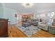 Open concept living room with hardwood floors, modern furnishings, and natural light at 1432 Gopher Loop, Tarpon Springs, FL 34689