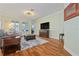 Inviting living room with hardwood floors, plush seating, and natural light, perfect for relaxation and entertainment at 1432 Gopher Loop, Tarpon Springs, FL 34689