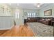 Comfortable loft area with hardwood floors, a plush sofa, and plenty of natural light from the windows at 1432 Gopher Loop, Tarpon Springs, FL 34689
