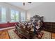 Main bedroom featuring hardwood floors, natural light from shuttered windows, and a luxurious dark wood bed frame at 1432 Gopher Loop, Tarpon Springs, FL 34689