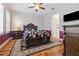 Well-lit main bedroom with hardwood floors, ceiling fan, and large bed at 1432 Gopher Loop, Tarpon Springs, FL 34689