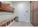 Mud room with built in bench, storage cubbies, wall hooks, and cabinet space at 1432 Gopher Loop, Tarpon Springs, FL 34689