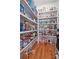 Spacious walk-in pantry with ample shelving, providing organized storage for all your kitchen essentials at 1432 Gopher Loop, Tarpon Springs, FL 34689