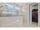 Walk-in shower room featuring tiled walls and decorative mosaic accents, plus walk-in closet at 1432 Gopher Loop, Tarpon Springs, FL 34689
