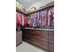 Custom walk-in closet with wood cabinets, drawers, shelving, hanging rods and ample storage space at 1432 Gopher Loop, Tarpon Springs, FL 34689