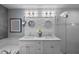 Bathroom with double vanity, decorative wall features and a glass enclosed walk-in shower at 14702 Dartmoor Ln, Tampa, FL 33624