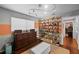 Spacious closet featuring custom shoe shelving, dresser and ottoman at 14702 Dartmoor Ln, Tampa, FL 33624