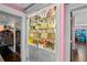 Chic closet featuring custom shelving with glass doors and many handbags at 14702 Dartmoor Ln, Tampa, FL 33624