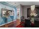 Elegant dining room with hardwood floors, modern decor, and a decorative mirror at 14702 Dartmoor Ln, Tampa, FL 33624