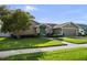 Beautifully landscaped front yard with a well-maintained lawn and a charming home exterior with great curb appeal at 14702 Dartmoor Ln, Tampa, FL 33624