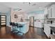Stylish kitchen featuring an island with bar stools, stainless steel appliances, and wood floors at 14702 Dartmoor Ln, Tampa, FL 33624