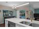 Kitchen counter with breakfast bar seating overlooks pool, equipped with modern appliances at 14702 Dartmoor Ln, Tampa, FL 33624