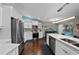 Bright, airy kitchen with white cabinets, stainless steel appliances, and views of the pool at 14702 Dartmoor Ln, Tampa, FL 33624