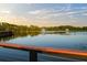 Picturesque lake view featuring a fountain and a scenic boardwalk surrounded by trees, creating a serene and natural landscape at 14702 Dartmoor Ln, Tampa, FL 33624