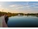 Picturesque view of the lake and boardwalk, featuring a fountain and a serene landscape for outdoor enjoyment at 14702 Dartmoor Ln, Tampa, FL 33624
