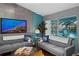 Cozy living room featuring a large TV and view of the screened-in pool area at 14702 Dartmoor Ln, Tampa, FL 33624
