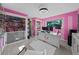 Bright pink office with custom doll display, custom desk and furniture at 14702 Dartmoor Ln, Tampa, FL 33624