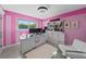 Bright pink office with custom 'doll house' display case at 14702 Dartmoor Ln, Tampa, FL 33624