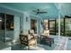 Comfortable outdoor seating area with ceiling fan, perfect for relaxing by the pool at 14702 Dartmoor Ln, Tampa, FL 33624