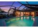 Inviting screened pool with lounge chairs and easy access to the home's interior, perfect for relaxation and entertainment at 14702 Dartmoor Ln, Tampa, FL 33624
