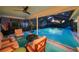 Relaxing screened-in pool area with comfortable seating, perfect for enjoying the outdoors in style at 14702 Dartmoor Ln, Tampa, FL 33624