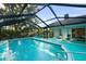 Beautiful screened pool area with ample seating and a tranquil backyard view at 14702 Dartmoor Ln, Tampa, FL 33624