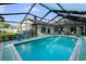 A pristine pool sits surrounded by lounge chairs and a beautifully landscaped backyard at 14702 Dartmoor Ln, Tampa, FL 33624