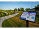 Kiwanis StoryWalk sign with a story panel along a paved walkway at 14702 Dartmoor Ln, Tampa, FL 33624
