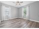 Bedroom featuring hard wood floors, a ceiling fan, and two bright windows at 14718 Rocky Brook Dr, Tampa, FL 33625