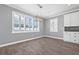 Bright dining area features wood-look tile floors, modern light fixture, and window with shutter at 14718 Rocky Brook Dr, Tampa, FL 33625