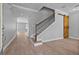 Bright foyer with wood-look tile floors, staircase with iron balusters, and stylish barn door at 14718 Rocky Brook Dr, Tampa, FL 33625