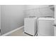 Bright laundry area featuring a white washer and dryer at 14718 Rocky Brook Dr, Tampa, FL 33625
