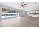 Bright open-concept living area with sliding glass doors to the pool and a modern ceiling fan at 14718 Rocky Brook Dr, Tampa, FL 33625