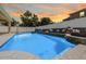 Inviting in-ground pool featuring waterfall accents and bench seating, perfect for relaxation and outdoor enjoyment at 14718 Rocky Brook Dr, Tampa, FL 33625