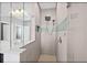 Walk-in shower featuring neutral tiling, modern fixtures, and a built-in shelf at 14718 Rocky Brook Dr, Tampa, FL 33625
