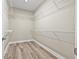 Walk-in closet with wire shelving and laminate wood flooring at 14718 Rocky Brook Dr, Tampa, FL 33625