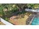 Spacious backyard featuring a fire pit, lush landscaping, and screened-in pool area perfect for outdoor entertaining at 1623 Carter Oaks Dr, Valrico, FL 33596
