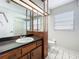 Bathroom features wood vanity, white sink, and separate shower and toilet at 1623 Carter Oaks Dr, Valrico, FL 33596
