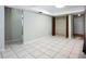 Tile bonus room with wooden closet doors and view into other rooms at 1623 Carter Oaks Dr, Valrico, FL 33596